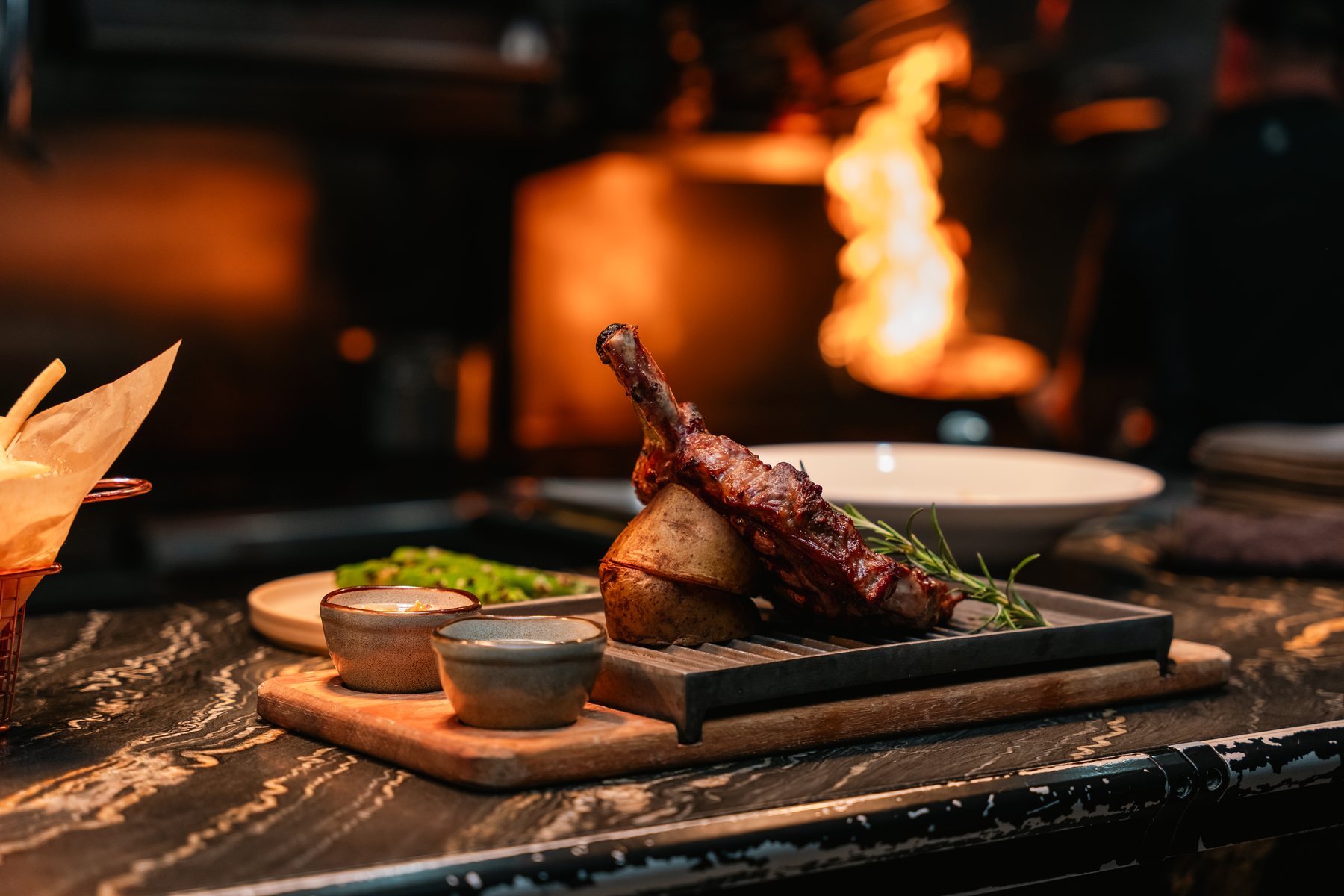 Open-flame hospitality photographed by Zu Group